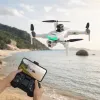 A white drone with black propellers and green light strips, including a handheld remote control and real-time display on a mobile phone details Picture